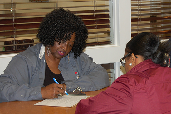 Sonya DuRonslet helps a customer prepare her taxes during Entergy Mississippi's Super Tax Day.